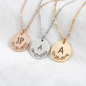 May include: Three gold, silver, and rose gold necklaces with round pendants. The pendants have engraved initials and dates. The pendants read "JP 01.30.2022", "A 08.05.2020", and "A 12.25.2016".