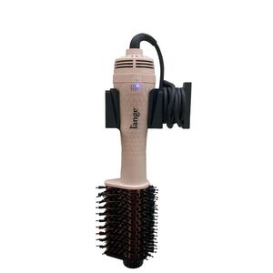 May include: A pink hair styling tool with a round brush attachment. The tool has the brand name "l'ange" printed on the handle. The tool is mounted on a black holder with a black cord.