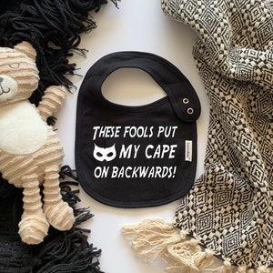 These Fools Put My Cape On Backwards Unisex Baby Bib - Funny Baby Bib, Superhero Humor, Baby Shower Gift