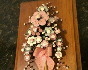 Vintage nail art wall plaque with nails for flowers on a wooden plaque