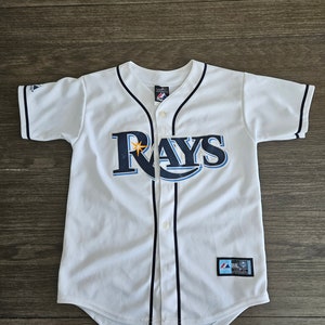 May include: White baseball jersey with blue and black "Rays" logo and a star. The jersey has a black collar and black stripes down the front.