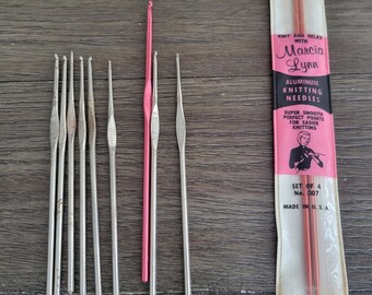May include: A set of eight knitting needles, including two sets of double-pointed needles in a pink package labeled "Knit and Relax with Marcia Lynn Aluminum Knitting Needles". The package includes the text "Super Smooth Perfect Points for Easier Knitting" and "Set of 4 No. 307 Made in U.S.A."