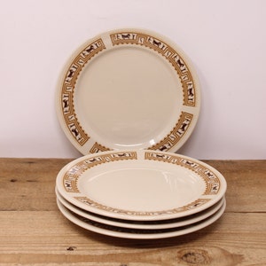 May include: Set of four white ceramic salad plates with a brown and gold geometric pattern around the rim. The pattern features stylised horses.