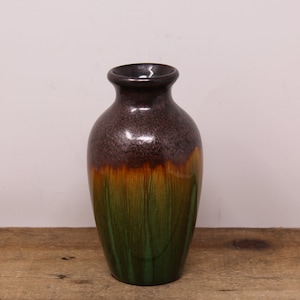 May include: A brown, orange and green ceramic vase with a glossy finish.