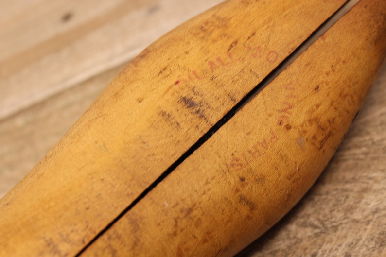 May include: A wooden shoe stretcher with a split design. The stretcher has red writing on it that says "FULL LAST" and "SUPER QUALITY".
