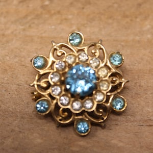 Vintage Gold Tone Flower Brooch with Blue Rhinestone Decor