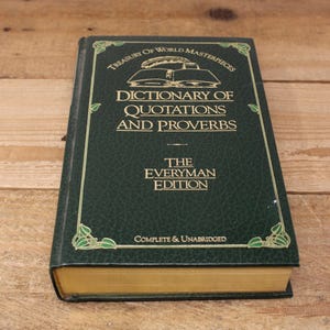 May include: A green hardback book titled "Treasury of World Masterpieces: Dictionary of Quotations and Proverbs, The Everyman Edition, Complete & Unabridged".