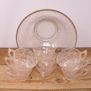 May include: A set of six clear glass punch cups with a pink crackle design and a matching clear glass punch bowl with a pink crackle design.