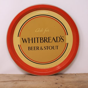 May include: Red and yellow round metal tray with black concentric circles and the text "Ask for WHITBREAD'S BEER & STOUT".