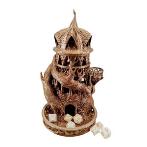 May include: A brown wooden tower shaped like a treehouse with a winding tree trunk base and a roof with a pointed spire. The tower has a small balcony and a door. There are six white dice with gold numbers on a wooden base.
