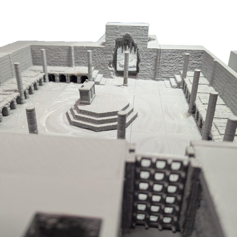 May include: A 3D printed model of a stone building with a central altar and columns. The model is painted in a light gray color.
