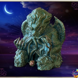 May include: A green and blue resin statue of Cthulhu, a fictional cosmic entity, with a large head, tentacles, and wings. The statue is sitting on a rocky base and has a small, multi-sided die in front of it. The background is a dark blue sky with a crescent moon.