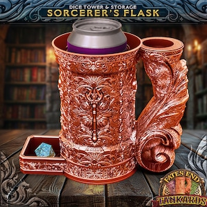 May include: A copper-colored metal dice tower and storage container with an ornate design. The tower has a built-in can holder and a drawer for dice. The container is labeled "Fates End Tankards".