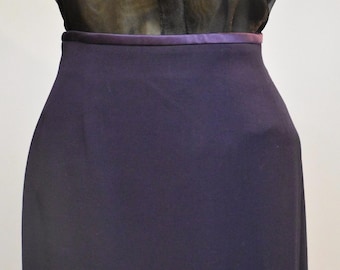 May include: A dark purple skirt with a satin waistband. The skirt is a simple, classic style.