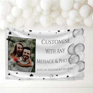 May include: A white banner with black stars and the text "CUSTOMISE WITH ANY MESSAGE & PHOTO LOTS OF DESIGNS & COLOURS". The banner features a photo of a couple and white and grey balloons.