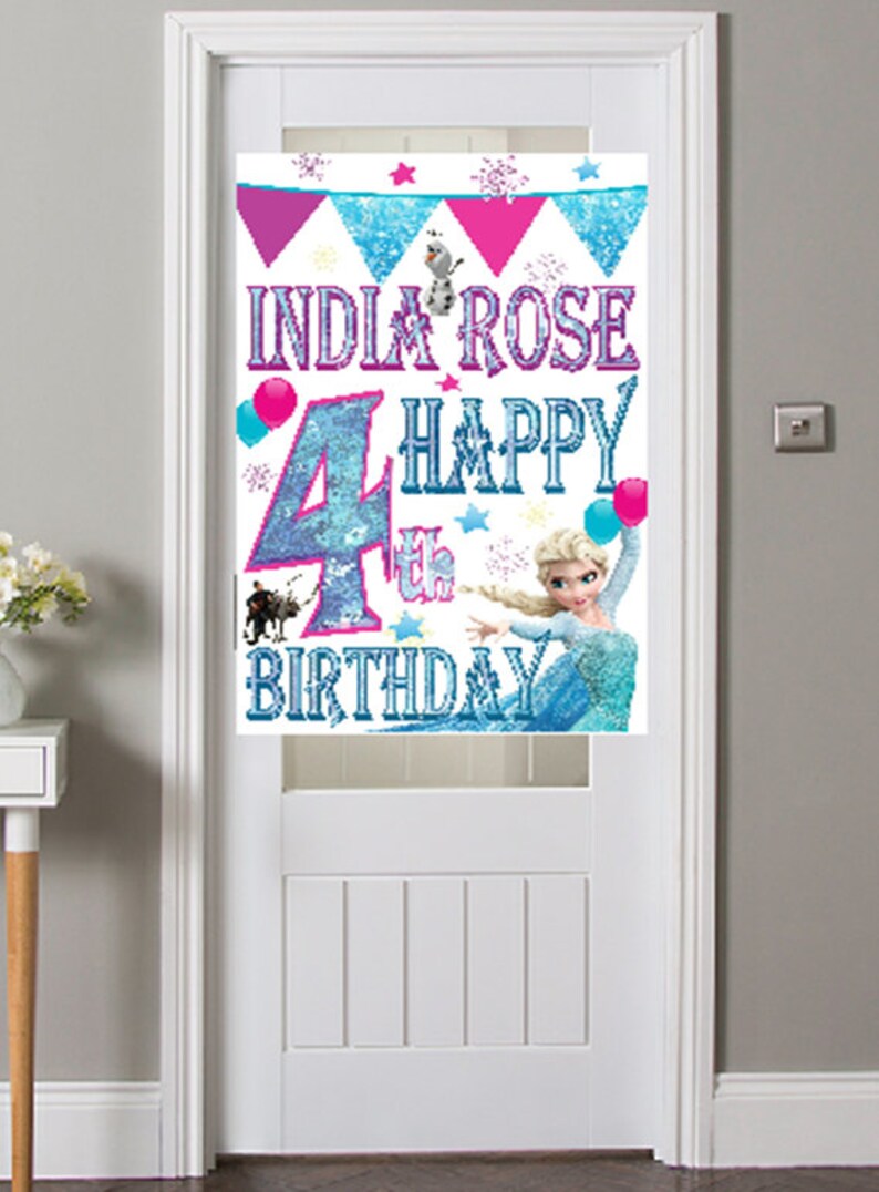May include: A Frozen-themed birthday banner with a blue and white glitter number 4, the words "India Rose 4th Happy Birthday", and a picture of Elsa from Frozen.