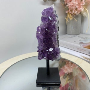 Amethyst Crystal on black display stand