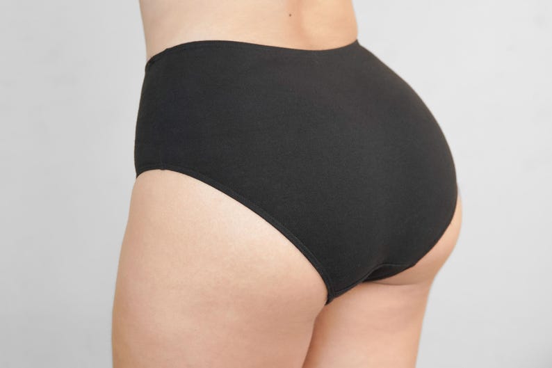 May include: Black high-waisted underwear with a smooth, seamless design.