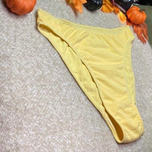 May include: A pair of yellow cotton underwear with a high leg cut.