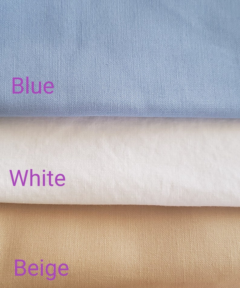 May include: Three fabric swatches, one blue, one white, and one beige. The swatches are stacked on top of each other.