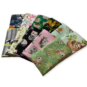 May include: A collection of eight fabric squares featuring various animal prints, including sloths, pandas, and koalas. The fabrics are in shades of green, black, pink, and gray, with some featuring bamboo and butterfly designs.
