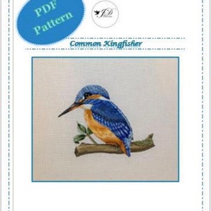 May include: A PDF pattern for cross-stitching a common kingfisher, a small blue and orange bird perched on a branch. The pattern is titled "Common Kingfisher" and includes a small logo with the initials "JD".