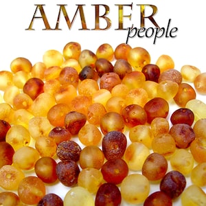 May include: A collection of amber beads in various shades of yellow, orange, and brown. The beads are smooth and polished, with a natural, organic look. Amber is a fossilised resin, and these beads are perfect for jewellery making or other craft projects.