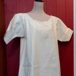 1920s . Old linen nightgown, lace at the collar.