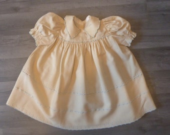 1950s . Little girl dress in beige cotton, embroidered. Handmade.