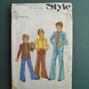 May include: A vintage sewing pattern for children's clothing. The pattern shows three boys wearing different styles of pants and shirts. The pattern is for size 6, chest 33 inches. The pattern is from the 1970s.