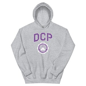 May include: A gray hooded sweatshirt with a purple print of the letters "DCP" and a circle with a castle and the text "College Program Est. 1981".
