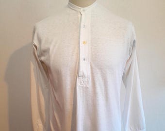 May include: White long-sleeve shirt with a mandarin collar and a button-down placket. The shirt is made of a lightweight fabric and has a relaxed fit. The shirt is displayed on a mannequin.