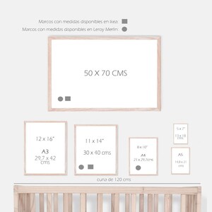 May include: A white wooden crib with a white wooden frame and a white mattress. There are four different sizes of picture frames with measurements in inches and centimeters. The text "cuna de 120 cms" is written below the frames.