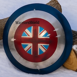 May include: A round shield with a blue outer ring, a silver middle ring, and a red center. The center features a Union Jack design. The text "WarriorsShield" is printed on the shield.