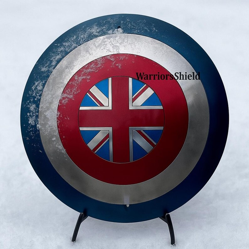 May include: A round shield with a blue outer ring, a silver middle ring, and a red center. The center features a Union Jack design. The text "WarriorsShield" is visible on the shield.