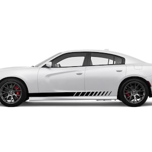 May include: A white sedan with black racing stripes along the lower side panels. The car has black wheels with red brake calipers. The image is a side view of the vehicle.