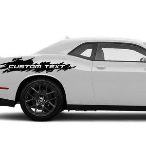 May include: A white Dodge Challenger with a black and white custom decal on the side. The decal features a jagged, distressed design with the text "CUSTOM TEXT".