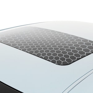 May include: A light blue car with a sunroof that has a black honeycomb pattern.