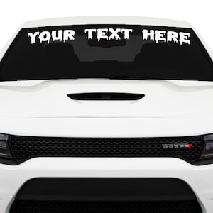 May include: White car with a black grille and the text "YOUR TEXT HERE" in dripping white letters on the windshield.