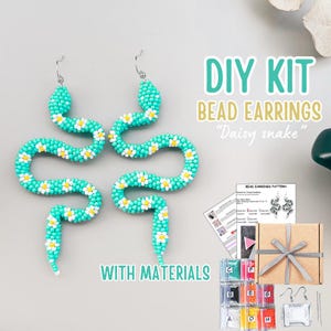 May include: A DIY kit for making beaded "Daisy snake" earrings. The earrings are turquoise with white and yellow daisy accents. The kit includes materials, a pattern, and a gift box.