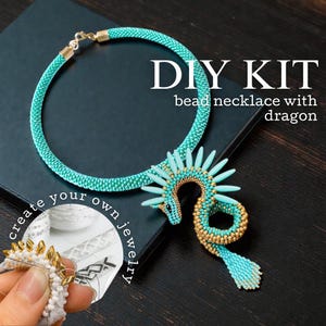 May include: A turquoise beaded necklace with a dragon design, part of a DIY kit. The necklace has gold accents. The image includes the text "DIY KIT" and "create your own jewelry."