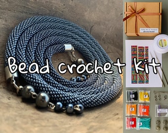 May include: A bead crochet kit with a variety of colored beads, needles, and instructions. The kit includes a black and silver beaded necklace, a colorful patterned design, and the text "Bead crochet kit".