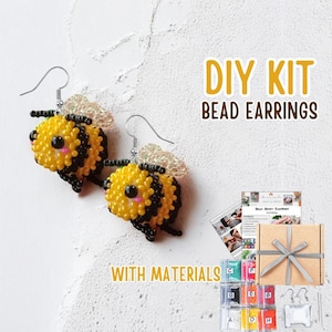 May include: A DIY bead earrings kit with materials. The image shows two beaded bee earrings with yellow and black beads, silver hooks, and clear wings. The kit includes a gift box, instructions, and various colored beads.