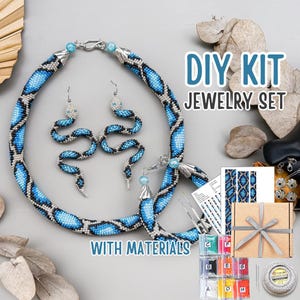 May include: A DIY jewelry set featuring a necklace, earrings, and bracelet with a blue and black snake scale pattern. The set includes materials and the text "DIY KIT JEWELRY SET WITH MATERIALS".