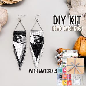 May include: A DIY bead earrings kit with materials. The image shows two black and white beaded earrings with a number 2 design. The kit includes a box, beads, and instructions. The text on the image says "DIY KIT BEAD EARRINGS WITH MATERIALS."