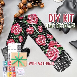 May include: DIY bead necklace kit with materials. The kit includes beads, thread, and instructions for creating a black beaded necklace with pink and white roses. The necklace has a fringe at the bottom.