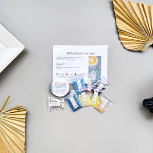 May include: Bead peyote pattern kit with instructions, beads in various colors, and a needle threader. The kit includes seven colors of beads: blue, yellow, red, white, green, and two shades of turquoise.