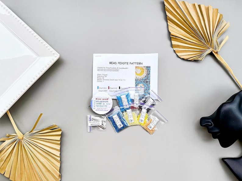 May include: Bead peyote pattern kit with instructions, beads in various colors, and a needle threader. The kit includes seven colors of beads: blue, yellow, red, white, green, and two shades of turquoise.