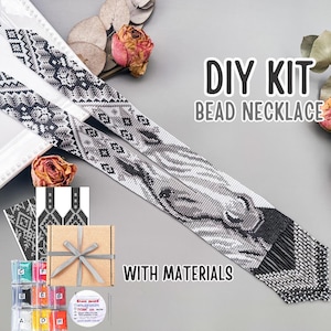 May include: A DIY bead necklace kit featuring a long, flat, woven strap with a black, white, and gray horse head pattern and geometric designs. The kit includes a cardboard box with a gray ribbon, labeled bead packets, and a spool of thread.