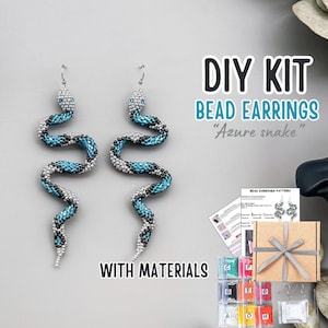 May include: DIY bead earring kit featuring "Azure snake" design. The kit includes materials and instructions to create beaded snake earrings. The earrings are blue, black, and silver, with a snake-like design.